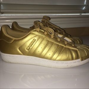 Gold Adidas Superstar sneakers